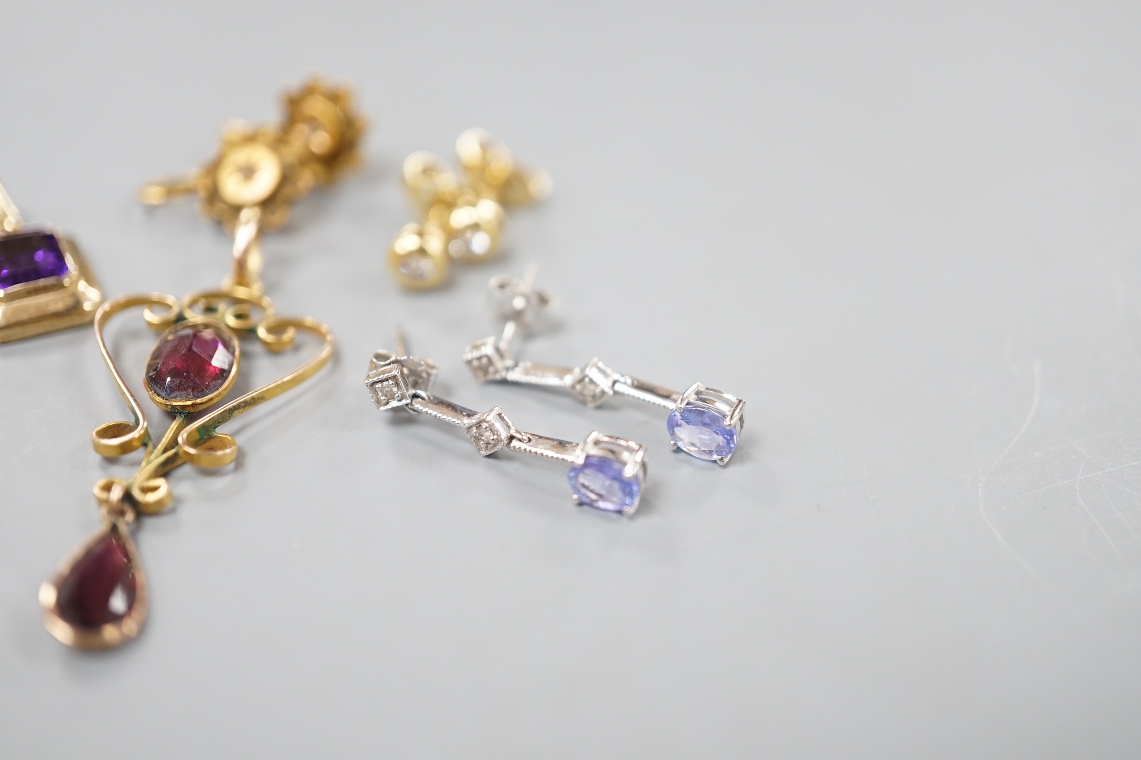 Mixed jewellery including a pair of Victorian 15ct and diamond chip earrings, a modern amethyst pendant, a garnet set yellow metal pendant, two pairs of 750 and diamond set ear studs, a pair of 750 white metal, tanzanite